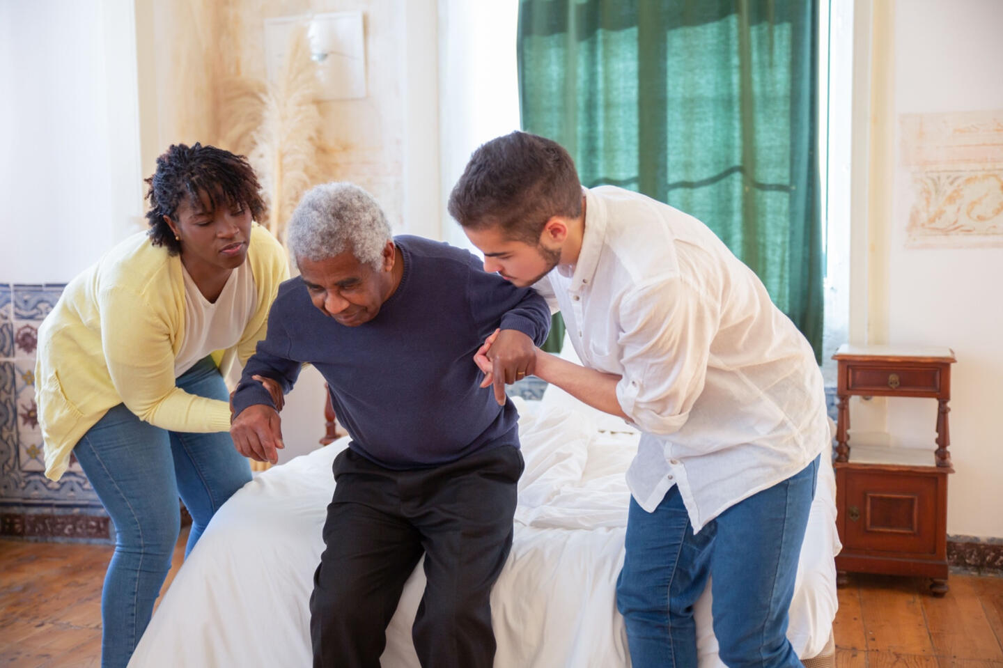 Caregivers assisting an elderly client with daily activities at home